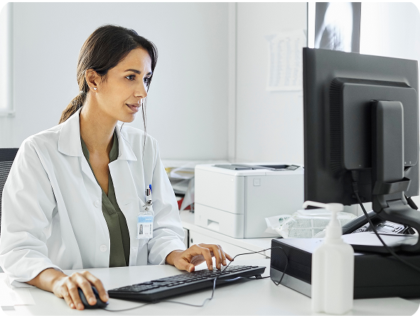 Nurse looking at a computer in an office